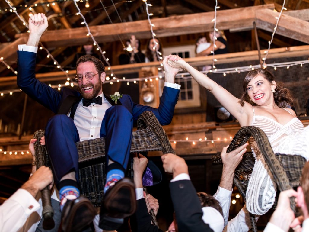 Guests lift the couple in chairs to dance the horah.
